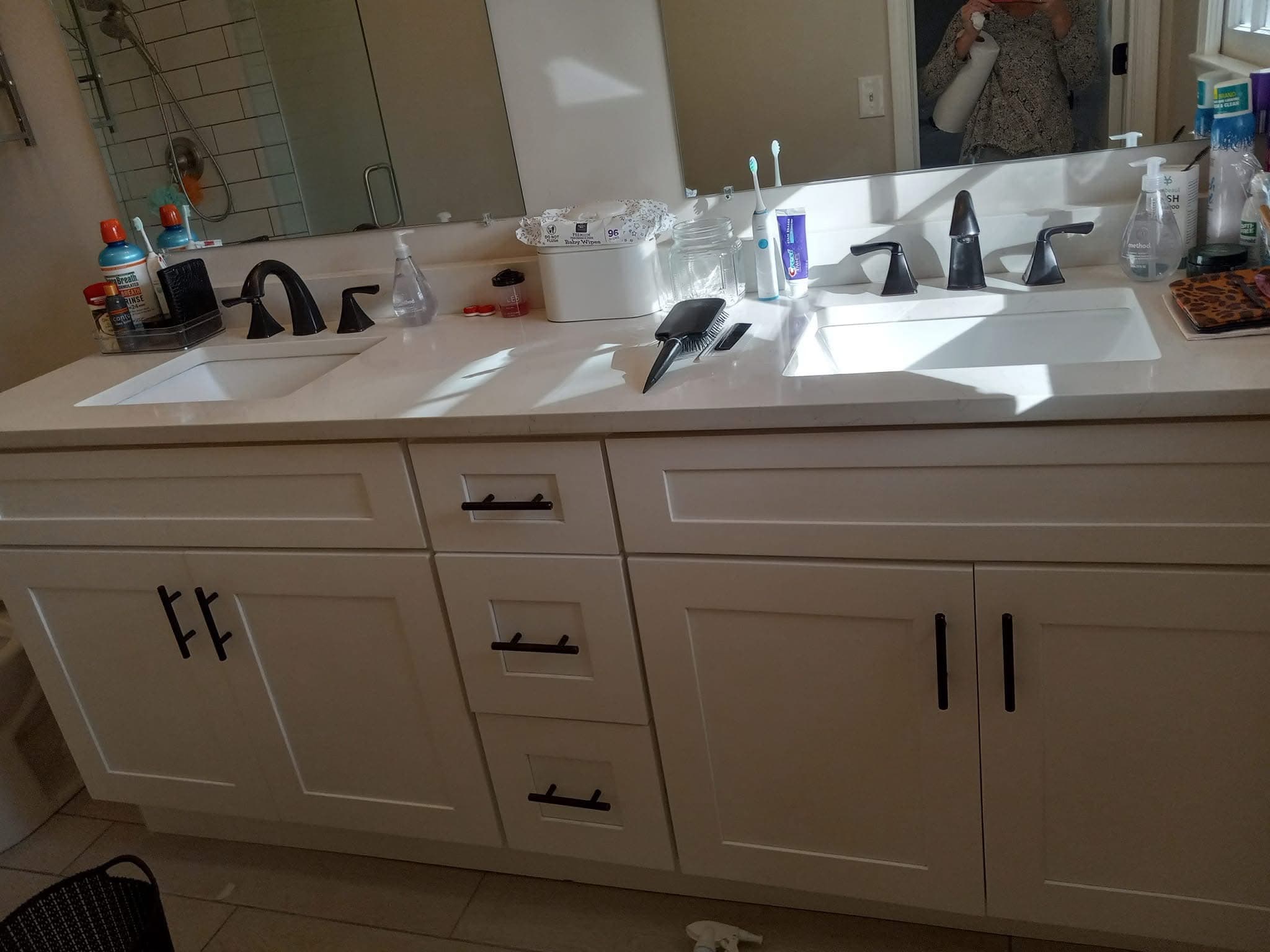 Double vanity with pristine white countertops and polished fixtures