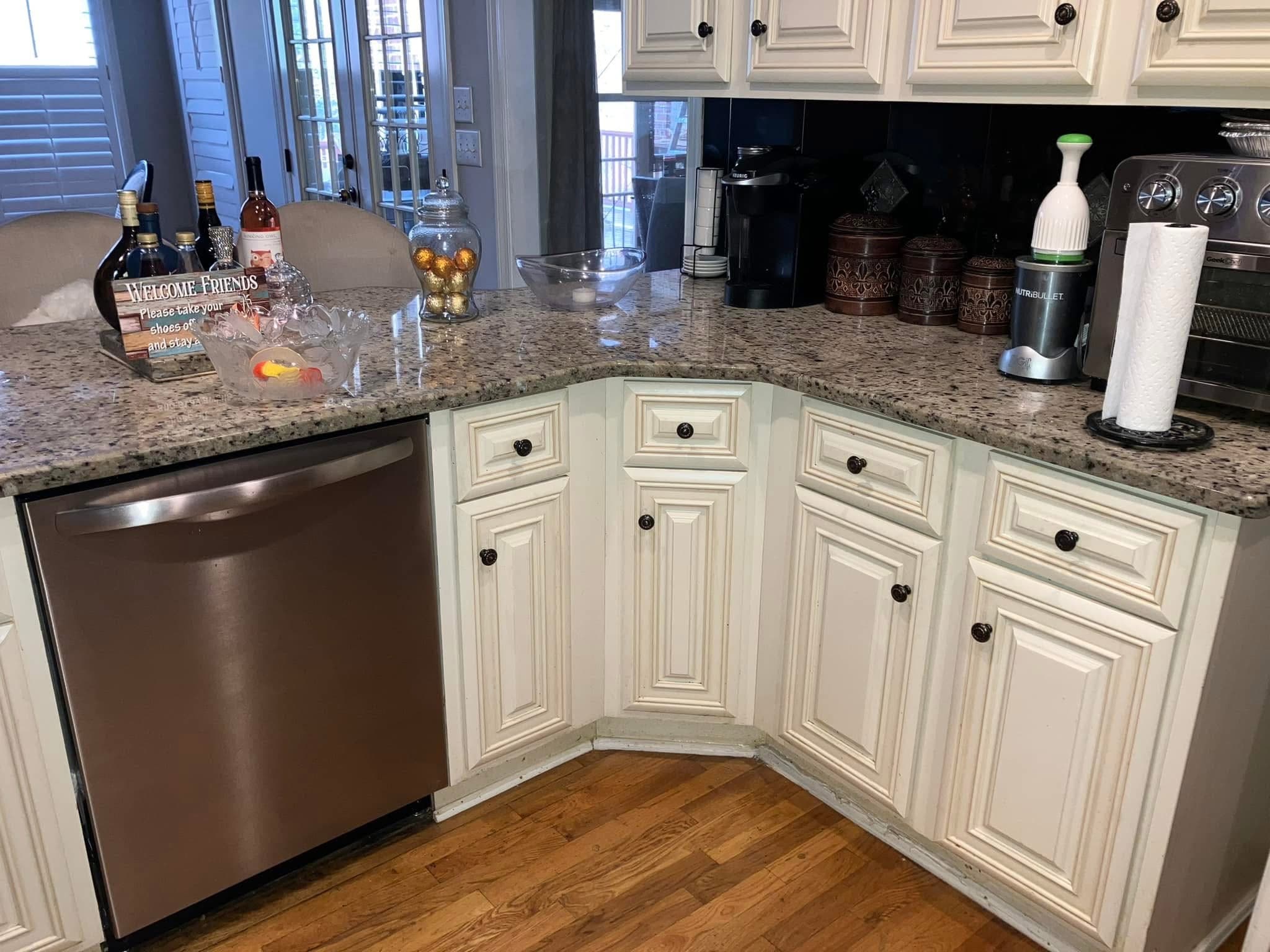 Upscale kitchen with granite counters and clean cabinets